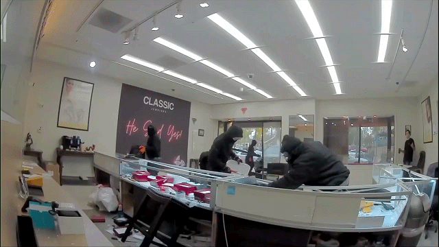 Video shows masked robbers crash car through jewelry store entrance, steal owner’s gun in brazen heist