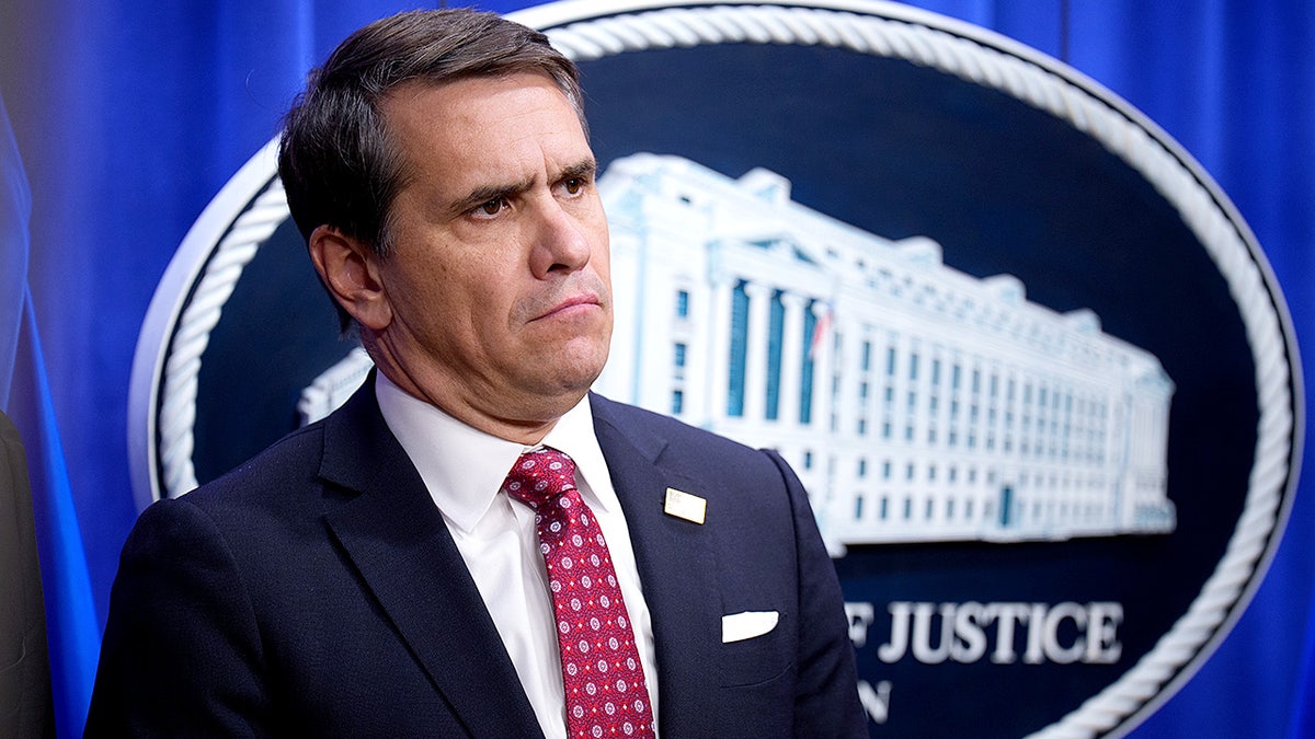 Deputy Attorney General Todd Blanche stands near a podium during a news conference inside the Justice Department.