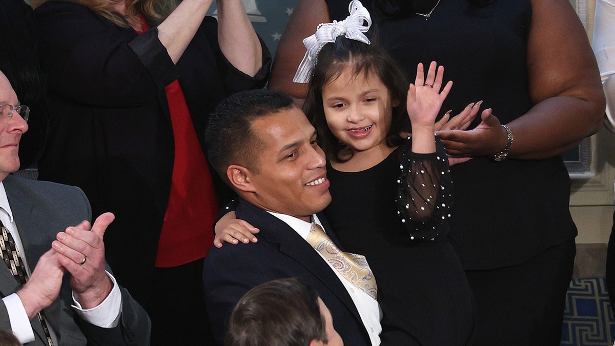 Marcus Coleman holds his daughter Dalilah Coleman.