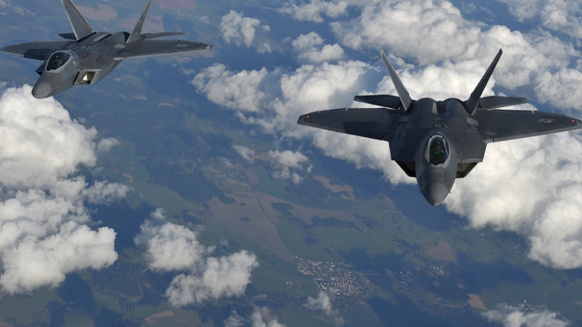 Two U.S. F-22 Raptor fighters fly over European airspace during a flight to Britain from Mihail Kogalniceanu air base in Romania April 25, 2016. REUTERS/Toby Melville - RTX2BM2B