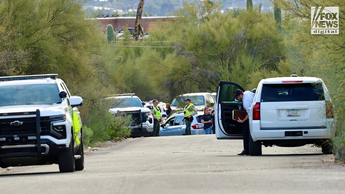 Pima County Sheriff's deputies assembling in front of Nancy Guthrie's home