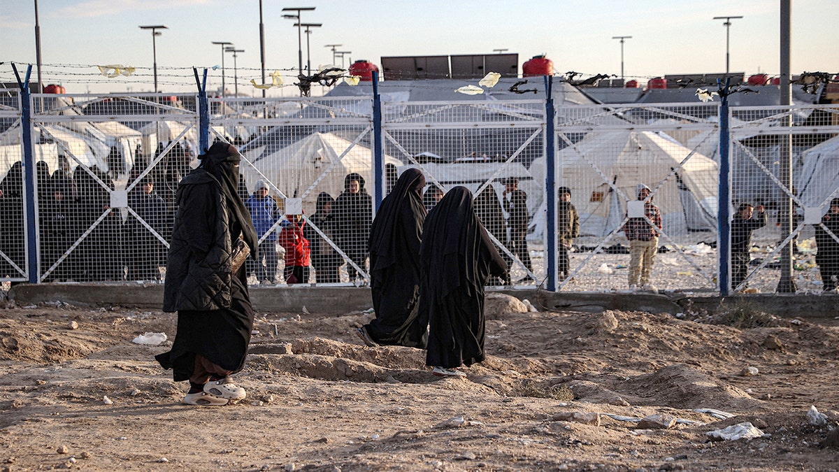 A wide encampment of tents shelters displaced families in a remote area.