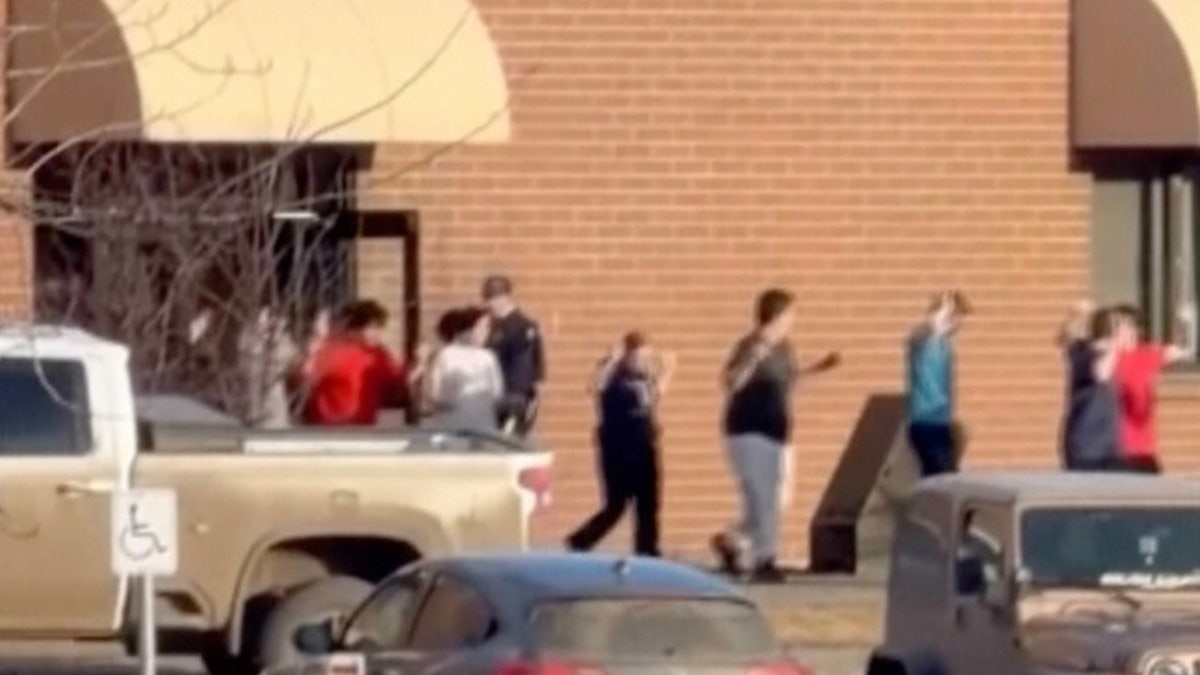 Students exit the Tumbler Ridge school after deadly shootings, in British Columbia, Canada, Tuesday Feb. 10, 2026. (Jordon Kosik via AP)