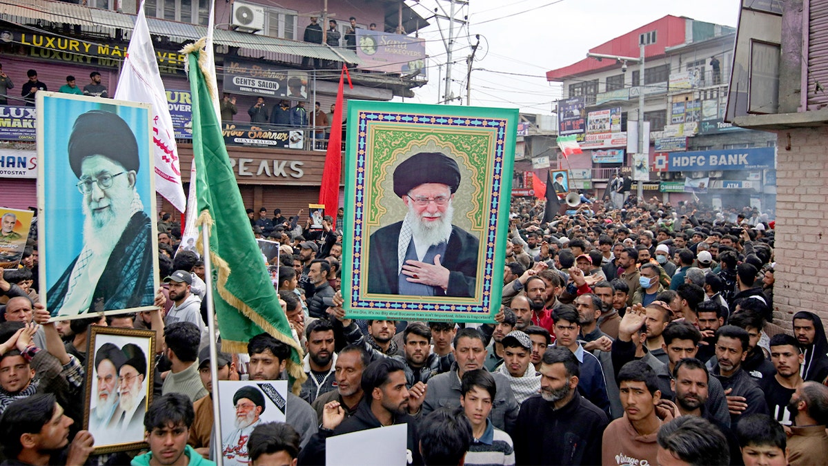 Kashmiri Shiite demonstrators march through Magam holding portraits of Iran’s supreme leader during a mourning procession.
